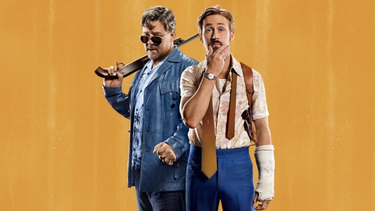 Two men in 1970s-style clothing stand against a textured gold background; the man on the left holds a shotgun across his shoulder, while the man on the right wears a cast on one forearm and rests his hand on his chin.