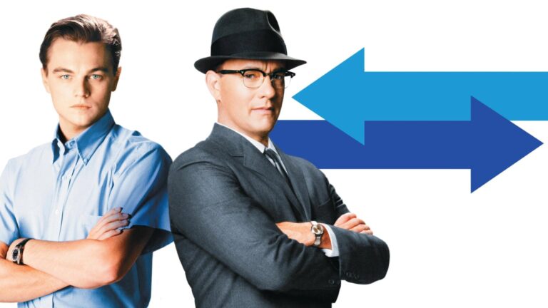 Two men stand with folded arms against a white background, with large blue arrows pointing in opposite directions behind them.