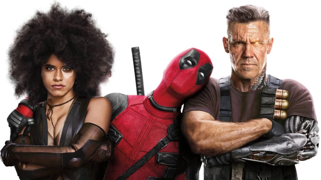 Three costumed action characters pose against a plain white background: a woman with a large afro at left, a red-and-black masked figure in the center, and a muscular man with a metallic arm at right.