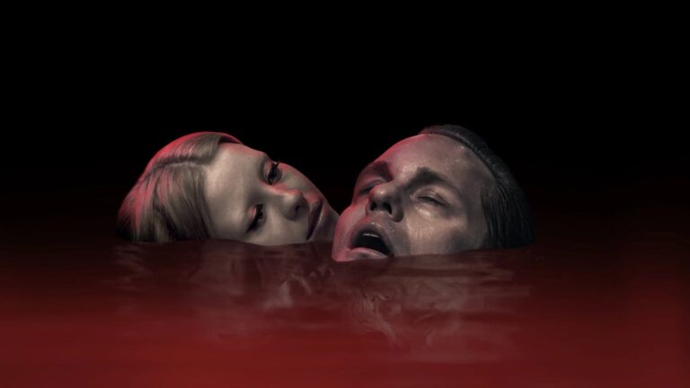Two pale-faced adults float in a dark red liquid beneath a black background, lit with ominous red highlights.