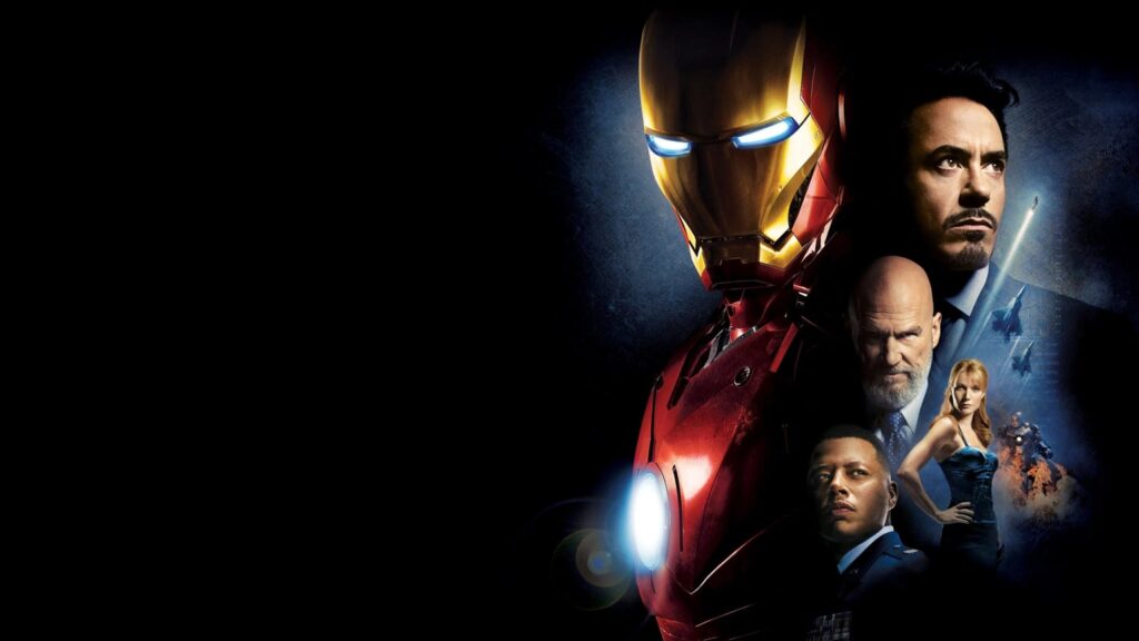 Dark widescreen promotional-style collage with a red-and-gold armored superhero, a glowing chest light, and several supporting human figures against a blue-black background; large empty black space fills the left side.