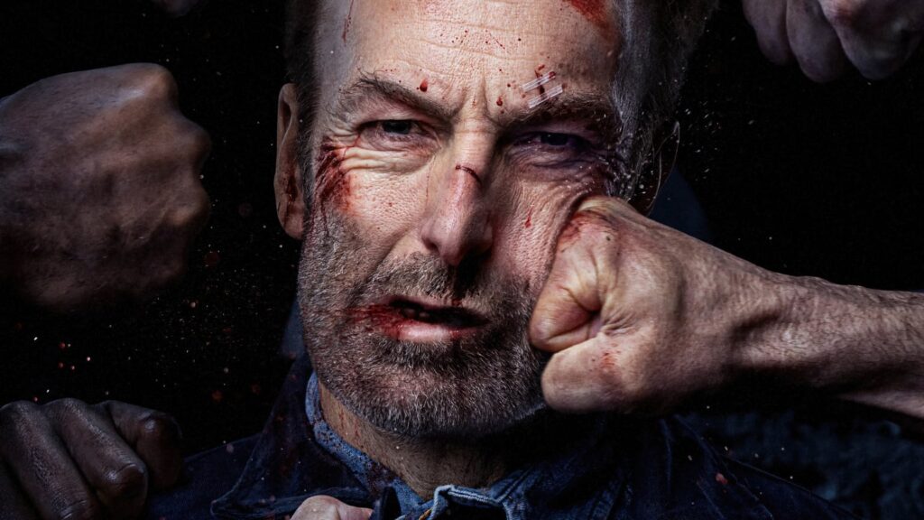 Close-up of a bruised, blood-smeared middle-aged man being punched in the face by several fists against a dark background.